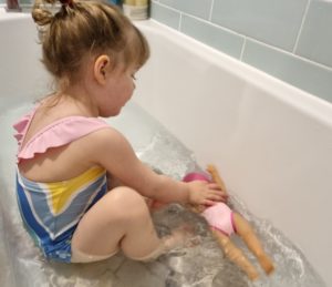 Ruby playing with BABY born Swim Girl in the bath